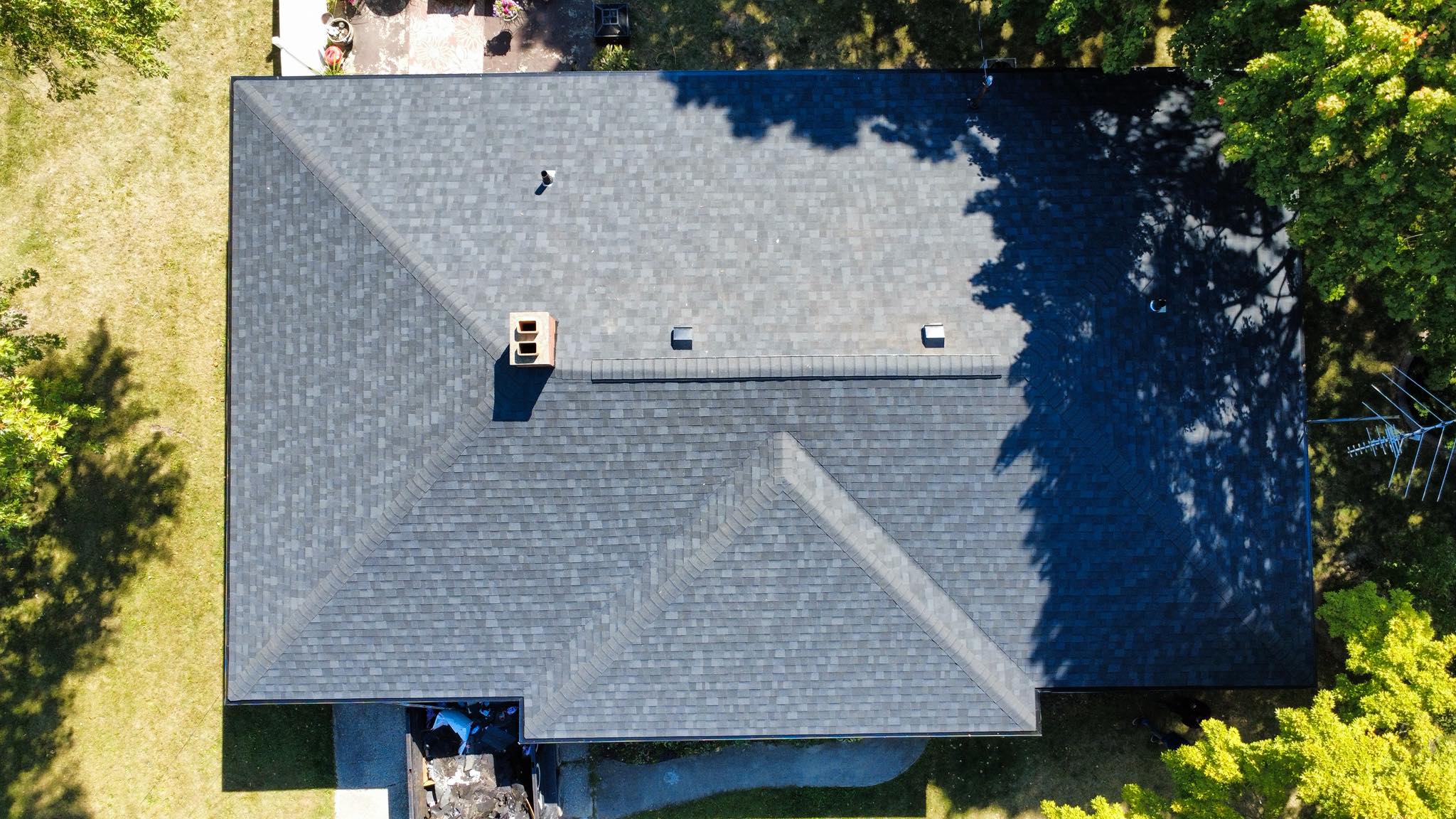 Top-down view of a full architectural shingle replacement