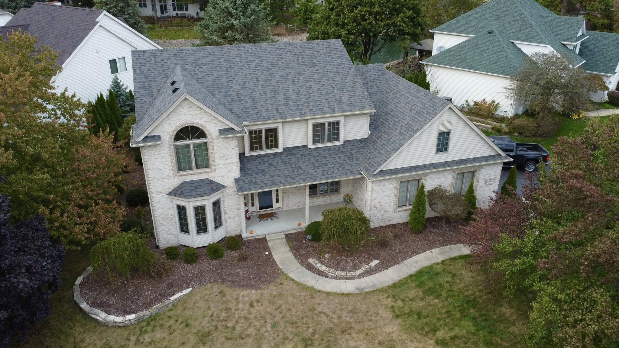 Two-story brick home with a new architectural shingle roof